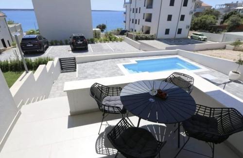 Kolan Apartment | Dolphin view II with a pool by the beach