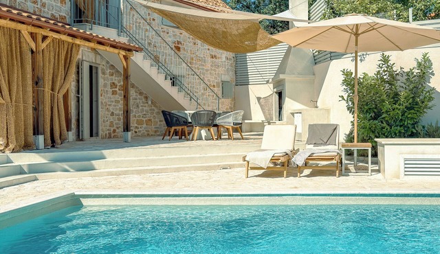 Modern expression of a traditional Hvar stone house amidst sunny nature. in Dol